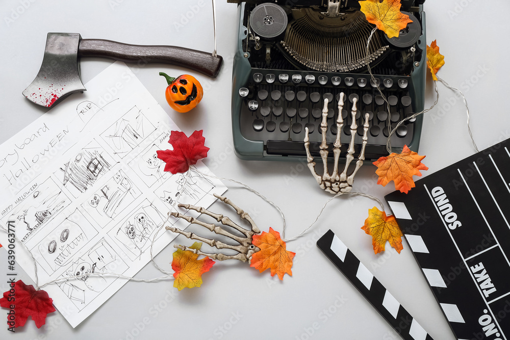 Wall mural Typewriter with clapperboard, storyboard and Halloween decor on grey background