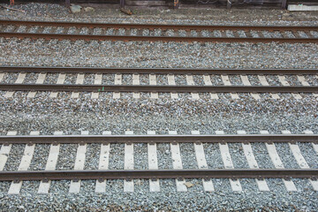 Railroad tracks and a train represent journey, connection, progress, and the passage of time in a single captivating visual