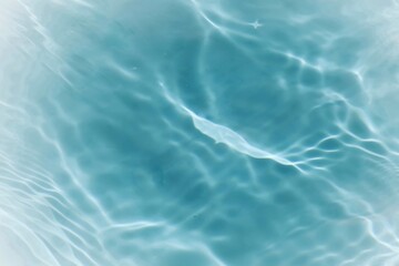 Blue water with ripples on the surface. Defocus blurred transparent blue colored clear calm water surface texture with splashes and bubbles. Water waves with shining pattern texture background.