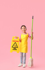 Cute little girl with mop and caution sign on pink background