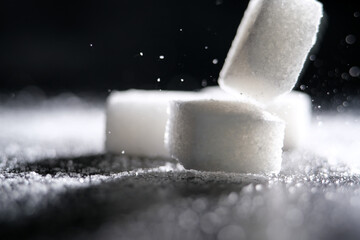 Close up of white cube sugar on black background