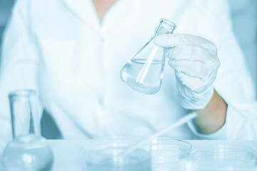Lab scenario: Assistant meticulously manipulates within the laboratory setting. Wearing a lab coat....