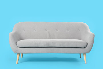 Cozy grey sofa on blue background