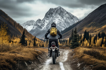 Male biker on motorcycle rides off-road in mountains in highlands, beautiful mountain landscape, clouds sky, autumn season. Active leisure, travel, sport concept. Generative ai . - Powered by Adobe
