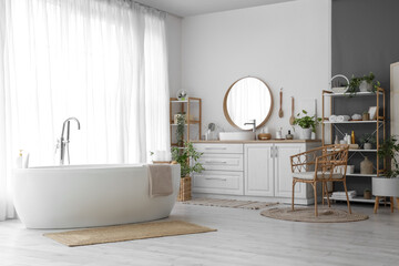 Fototapeta na wymiar Interior of light bathroom with sink, accessories and bathtub