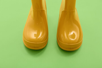 Yellow gumboots on green background
