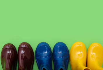 Different gumboots on green background