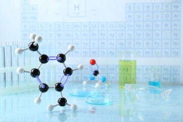 Molecular model and laboratory equipment on light surface