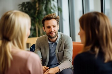 selective focus of smiling psychotherapist talking to couple in office