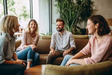 Happy group of friends sitting on sofa and talking in living room at home