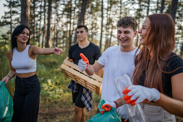 teenage friends young men women pick up waste garbage to clean forest