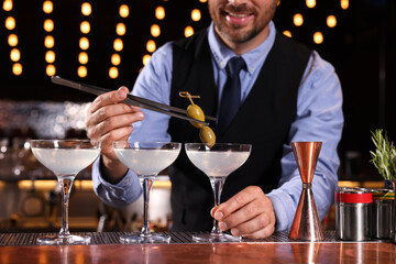 Bartender preparing fresh alcoholic cocktail in bar, closeup
