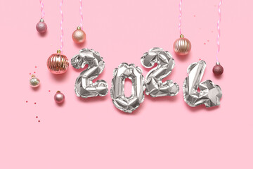 Figure 2024 made of balloons with Christmas balls on pink background