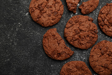 Tasty chocolate cookies on grey textured table, flat lay. Space for text
