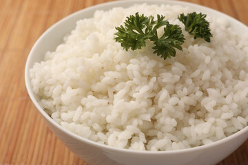 Bowl with delicious rice and parsley on bamboo mat, closeup