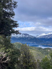 Beautiful range of snowy mountains and a lake with blue sky above in Bariloche Argentina, amazing panoramic view at Circuito Chico Patagonia.