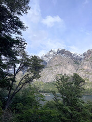 Beautiful range of snowy mountains and a lake with blue sky above in Bariloche Argentina, amazing panoramic view at Circuito Chico Patagonia.