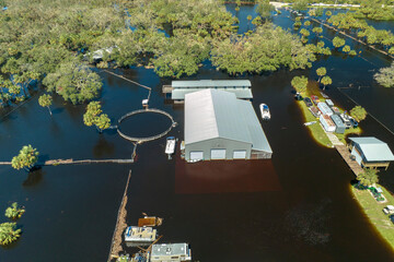 Consequences of natural disaster. Flooded industrial business warehouse by hurricane Ian rainfall...