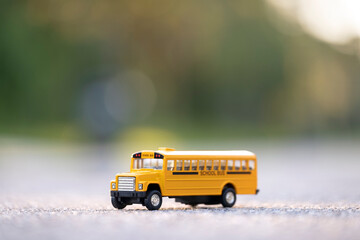 Model of classical american yellow school bus for transporting of kids to and from school every day. Concept of education in the USA © bilanol