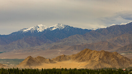 Panoramic view of high-altitude snowcapped mountain ranges of Ladakh, India 