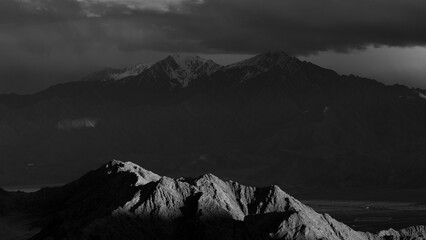 A landscape of light and shadows falling on mountains as fine art