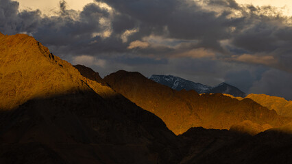 A panoramic landscape of light and shadows falling on mountains as fine art