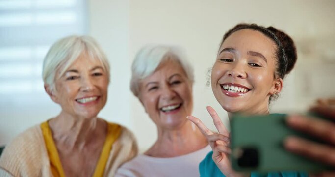 Senior women, friends and selfie with nurse, peace sign or happy for post, web blog or support in house. Caregiver, elderly people or smile for memory, profile picture or social media in nursing home