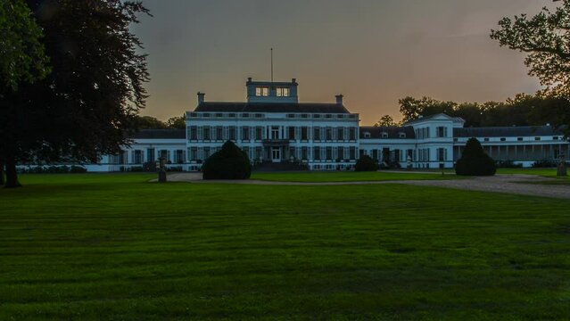Time lapse of a beautiful old palace while the sun is setting - zoom out