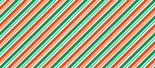Red and green Christmas seamless pattern. Candy cane diagonal stripes background. Repeating decoration wallpaper. Winter holiday lines backdrop. Xmas peppermint present wrapping print design. Vector