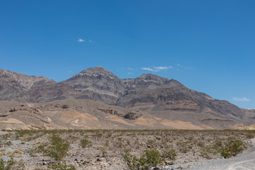Scenic view of vertical buff sandstone and limestone cliffs of Rainbow Mountain Wilderness Range in Mojave Desert near Las Vegas, Nevada, United States. Hiking outdoor activity in remote natural area
