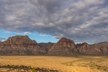 Scenic sunrise view of limestone peaks Mount Wilson, Bridge and Rainbow Mountain of Red Rock Canyon National Conservation Area in Mojave Desert near Las Vegas, Nevada, United States. Remote hiking