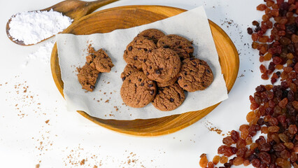 Pile of Delicious Chocolate Chip Cookies on a Wooden Plate. White background