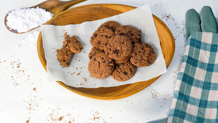 Pile of Delicious Chocolate Chip Cookies on a Wooden Plate. White background