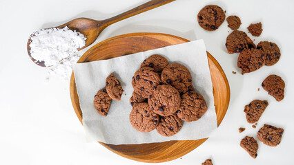 Pile of Delicious Chocolate Chip Cookies on a Wooden Plate. White background