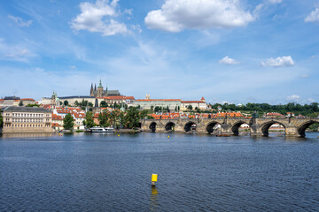 Naklejka premium View of the river Vltava in Prague with the Charles Bridge and the Castle Hradcany