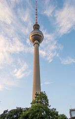 The iconic TV Tower of Berlin shone by the last warm rays of sunlight