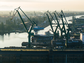 Fototapeta na wymiar Cranes in Gdansk Shipyard Aerial View. Motlawa River Industrial Part of the City Gdansk, Pomerania, Poland. Europe.