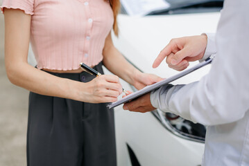Naklejka premium Customers and car insurance agents have entered into agreements and signed documents to claim compensation after a car crash, Insurance concept