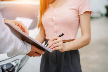 Obraz na płótnie Canvas Customers and car insurance agents have entered into agreements and signed documents to claim compensation after a car crash, Insurance concept