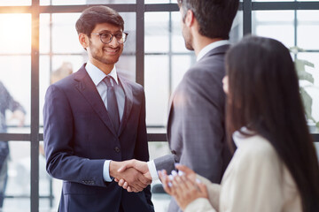 Group managers or employees standing in modern office hall after staff briefing and discussing corporate news