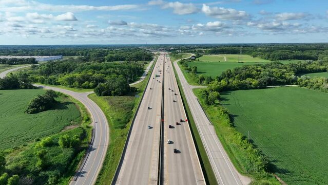 Multi lane highway in United States midwest. Aerial shot above traffic on wide interstate freeway during the summer.