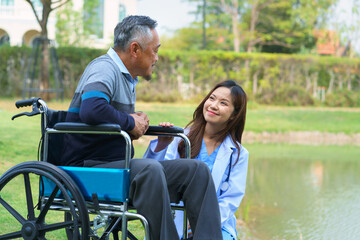 Smiling pretty caregiver and old man with walking at hospital. concept healthcare