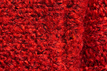 Micro close up of red wooly crochet fabric with copy space