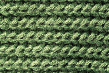 Micro close up of green wooly knitted fabric with copy space