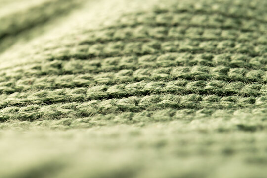 Fototapeta Micro close up of green wooly knitted fabric with copy space