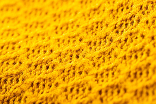Fototapeta Micro close up of yellow crocheted woolly fabric with copy space