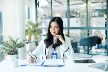 Asian businesswoman calculate financial graphs showing results about their investments, planning...