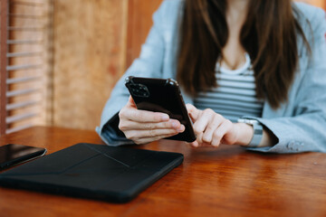 Confident businesswoman working on laptop,tablet and smartphone at her workplace at office..