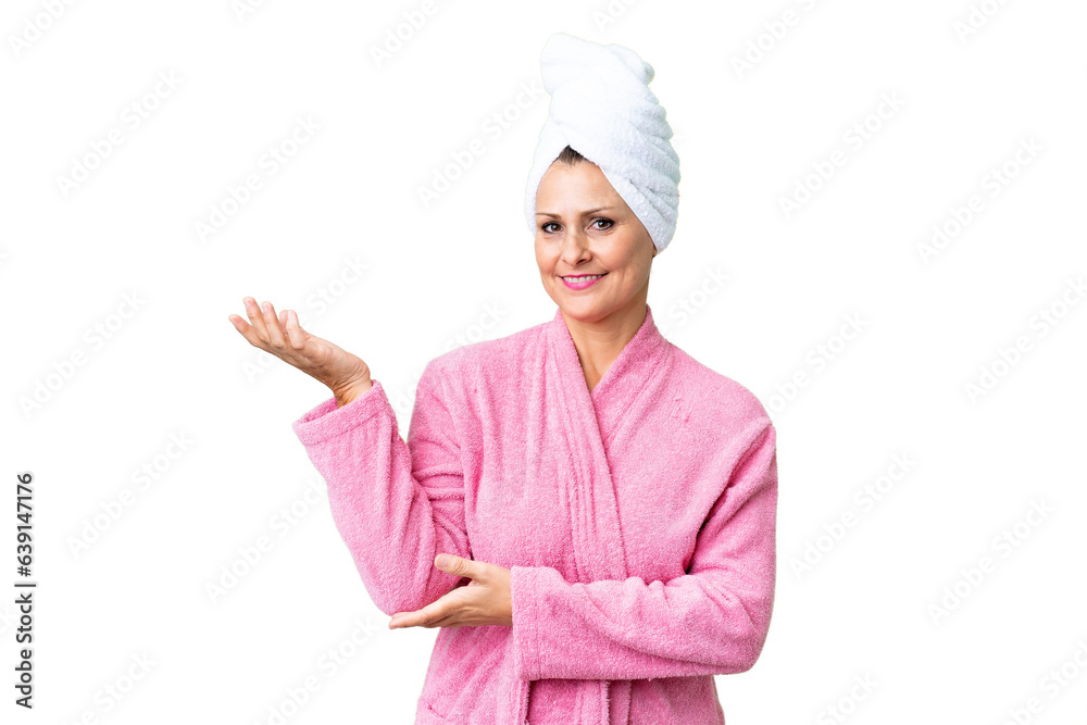 Canvas Prints Middle age caucasian woman in a bathrobe over isolated background extending hands to the side for inviting to come