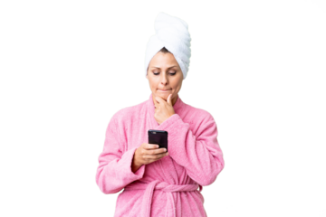 Middle age caucasian woman in a bathrobe over isolated background thinking and sending a message